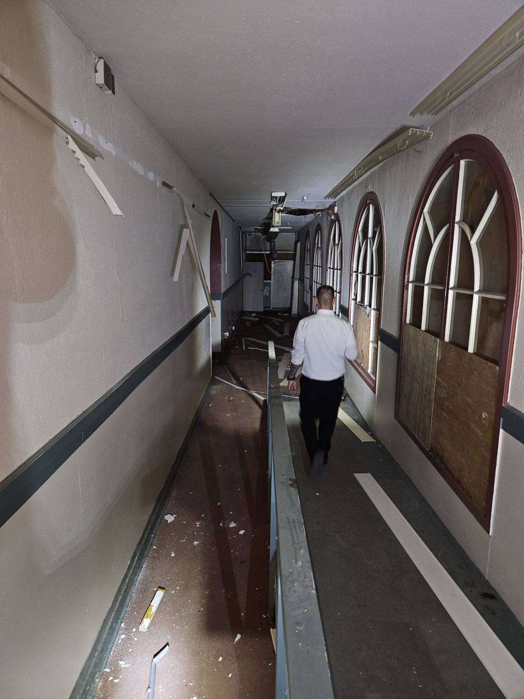 Interior hallway lined with tall arched windows